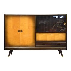 an art deco cabinet with two doors and drawers