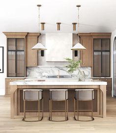 a large kitchen with wooden cabinets and marble counter tops, along with two pendant lights hanging from the ceiling