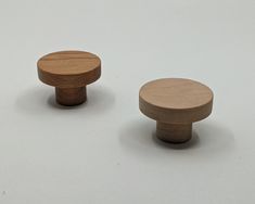 two wooden knobs on a white surface