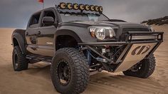 the truck is driving through the sand dunes