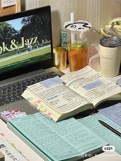 an open book sitting on top of a laptop computer