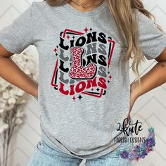 Pick yourself up one of these fun and spirit-filled Lions shirts. This shirt is sure to impress your friends and show your true Lions spirit. .  It's a soft shirt in an ash gray color with a midweight feel. This shirt is made of 95% polyester and  5% spandex. It's nice and soft with great stretch.  Some shirts may be 100% polyester depending on availability. To get the best wear from your shirt make sure to  1. Wash in cold water 2. Tumble dry low 3. Do not iron on design area 4. Do not use fabric softener This shirt is made by an ink print process. This specific shirt design is made to be a soft, vintaged look. Minor fading may occur after the first wash to enhance the vintage look School Spirit T-shirt For Game Day, Relaxed Fit, Game Day School Spirit T-shirt With Heat Transfer Vinyl, School Spirit T-shirt Relaxed Fit For Game Day, Relaxed Fit T-shirt For Game Day With School Spirit, Casual Football Season Sublimation Design, Casual Red T-shirt For Cheerleading, Casual Game Day T-shirt With Sublimation Team Name, Casual Sublimation Design With Letter Print For Game Day, Casual Tops With Sublimation Print For Football Season