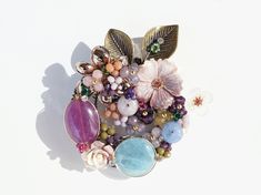 I designed and handcrafted this elegant brooch of flower crown that features natural Jades & Stones with mother of pearl.  A delicate cluster of stone beads are wire sculptured that would look more beautiful! Wonderful gift idea for Mother, Grandma, Daughter, Sister, Friend or for your self!! You can wear this as a pin or as a pendant on any chains.    - overall size : 60mm x 55mm  - All jewelry items come to you carefully gift-wrapped, ready for giving or as a special treat for yourself. Thank Unique Flower Shaped Brooches For Gift, Handmade Wedding Brooches, Handmade Round Wedding Brooches, Handmade Flower Brooches As Gift, Handmade Flower Brooches For Gifts, Unique Handmade Flower Brooch, Unique Handmade Flower Brooches, Gold Brooches With Handmade Flowers For Gifts, Gold Handmade Flowers Brooch Gift