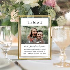 a table with two wine glasses and a sign that says, table 1 next to it