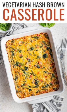 a casserole dish with spinach, cheese and other vegetables on the side