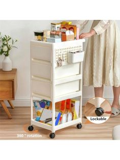 a woman standing next to a white cart with lots of items on top of it