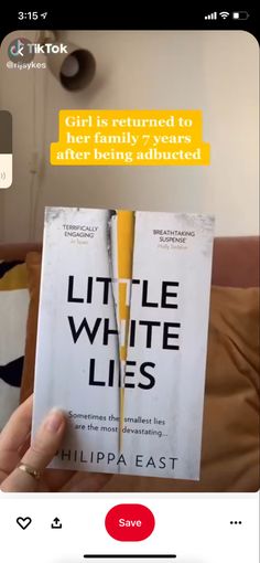 someone holding up a copy of the book little white lies by chilpa east