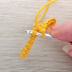 someone is crocheting the end of a piece of yarn