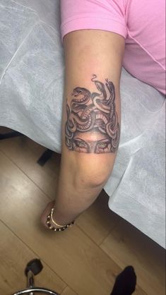 a woman's arm with a tattoo on it and a snake in the middle