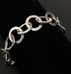 "Fashion Canada 925 Silver Flat Circle Link Toggle Bracelet. Stamped Hallmark: C^A and 925 on the bracelet. Good condition, dress your wrist in the link sterling silver bracelet. Featuring circle link design, this bracelet is the perfect example of authentic. Length: 9\" (22.86 cm) ;  Circle diameter: 1.43 cm Weight: 25 grams (0.81 troy oz) Please see pictures and description carefully. We have no return and exchange policy. Ask for help if you have any questions." Sterling Silver Chains Flat Disks, Nickel-free Sterling Silver Oval Link Bracelet, Nickel Free Link Bracelets, Nickel-free Sterling Silver Chain Link Bracelet, Sterling Silver Bracelet With Solid Link Construction, Nickel-free Link Bracelets, Hypoallergenic Sterling Silver Link Jewelry, Nickel Free Sterling Silver Link Bracelet, Sterling Silver Toggle Clasp Bracelet Gift