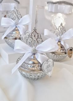 two silver baskets with white bows and hearts