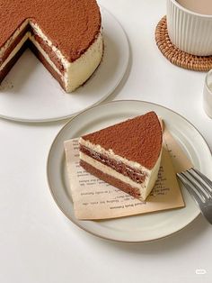 there is a piece of cake on the plate next to a cup and saucer