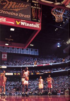 the basketball players are playing on the court in front of an audience at a game