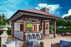 an outdoor bar and seating area with blue cushions