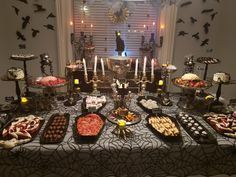 a table topped with lots of food and candles