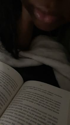 a close up of a person reading a book