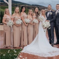 a group of people standing next to each other in front of a white gazebo