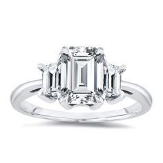 an emerald - cut diamond ring with three baguets on the shoulders and sides