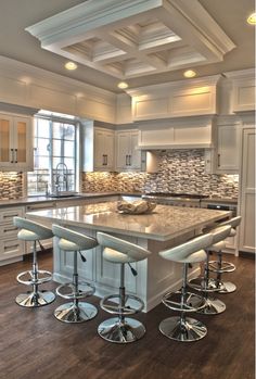 a large kitchen island with four stools in it