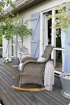 a rocking chair sitting on top of a wooden deck