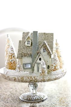 a cake plate with a small house on it