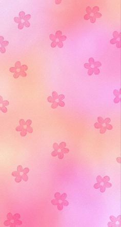 a pink background with small flowers on the bottom and one flower in the middle is blurry