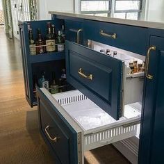 an open cabinet in the middle of a kitchen