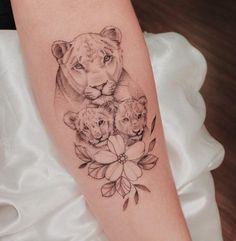 a woman's arm with an animal tattoo on it