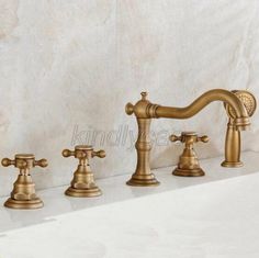 three faucets are lined up next to each other