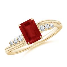 a gold ring with a red stone and diamonds