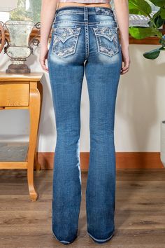 Mid-rise dark wash boot cut denim with zigzag designs with gems. 73% Cotton. 24% Viscose, 3% Elastane Machine wash inside out in cold water with like colors. Dry flat. Front Rise: 9"; Back Rise: 14" Inseam: 34" Style No. M3994B-K1317 Rhinestone Denim Flare Jeans Straight Leg, Fitted Straight Leg Rhinestone Jeans, Fitted Mid-rise Jeans With Rhinestones, Fitted Straight Leg Jeans With Rhinestones, Fitted Denim Flare Jeans With Rhinestones, Mid-rise Denim Flare Jeans With Rhinestones, Fitted Embellished Medium Wash Jeans, Embellished Flare Jeans For Spring, Medium Wash Rhinestone Denim Jeans