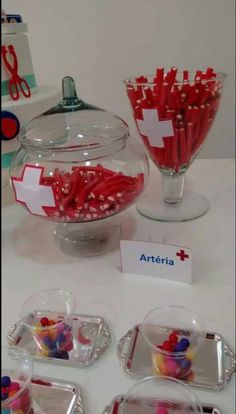 candy and candies are on display in clear bowls with name tags attached to them