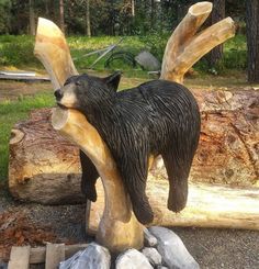 a statue of a bear on top of a log