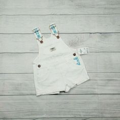 Nwt Oshkosh White Denim Shortalls. Light Blue Embroidered Flowers On Straps And Left Pocket. Adjustable Straps. Size 12 Months 100% Cotton 6 Oz Cute Shortalls With Pockets For Playtime, Cute White Overalls For Spring, White Overalls For Playtime In Spring, Spring Playtime White Overalls, White Overalls For Spring Playtime, Cute White Cotton Overalls, Denim Shortalls, White Denim, Embroidered Flowers