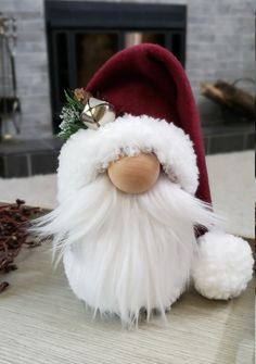 a santa clause doll sitting on top of a table