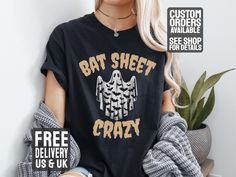 All T-shirts are Unisex. See Images for size charts. A Funny Halloween T-Shirt with the phrase 'Bat Sheet Crazy' and an image of a sheet ghost costume with bats printed on it. This T-Shirt gives off a festive and playful vibe, perfect for Halloween parties or events. It is relevant to those who enjoy humor and dressing up for the holiday. See more of our Halloween designs here  https://www.etsy.com/uk/shop/HeavyMetalCasualTees?ref=seller-platform-mcnav&section_id=49979763 See more of our T-Shirt Halloween Band Merch Tops With Letter Print, Halloween Themed Relaxed Fit Shirt With Letter Print, Halloween Relaxed Fit Shirt With Letter Print, Halloween Text Print Relaxed Fit Top, Halloween Relaxed Fit Top With Text Print, Halloween Letter Print Fan Merchandise Top, Relaxed Fit Halloween Top With Text Print, Black Novelty Top With Custom Print, Halloween Novelty Tops For Fans