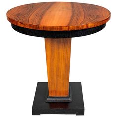 a wooden table sitting on top of a black base with a wood slab at the bottom