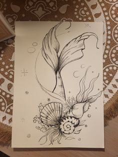 a drawing of a fish and flowers on paper