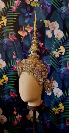 I adore unusual headdresses and crowns and was do pleased when this turned up on my travels! An authentic piece of Thai Dance costume, which makes a statement both worn or as an interior display piece. They are made from light wood and a form of moulded papier mache. Painted with rich gold paint and decorated with discs of fine metal and paste stones. This does come apart in 2 pieces and has a stand to display. When assembled, from the front browline to top, it measures 43.5cm The inner crown me Thai Dance, Interior Display, Costume Hats, Dance Costume, Light Wood, Gold Paint, Dance Costumes, Headdress, Fabric Collection