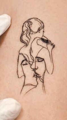 a woman's stomach with a drawing of a man holding a girl on it