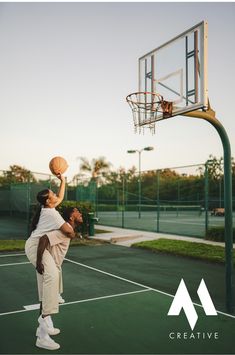 two people playing basketball on an outdoor court