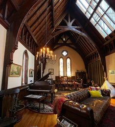 a living room filled with furniture and a grand piano