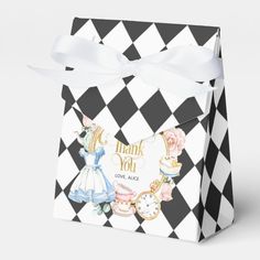 a black and white checkered box with an image of alice in wonderland on it