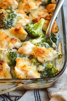 broccoli and chicken casserole in a glass dish with a silver spoon