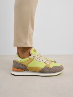 The DEAUVILLE sneakers epitomize authenticity and versatility in their design. They shine with a vibrant palette of citrusy greens, from zesty lime to subtle hints of mustard and khaki. The fusion of textures—suede, fabric, and rubber—creates an exclusive and singular design. Featuring a padded front and memory-foam insole, they offer exceptional comfort. Perfect for days brimming with activity, whether exploring art galleries, strolling in your favorite city, or during your daily routine. Sole Lime Green Sneakers, 90s Sneakers, Sneaker Cleaner, City Sneakers, City Silhouette, Brand Icon, Green Sneakers, Soft Bristle Brush, Suede Fabric