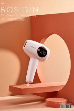 an electric hair dryer sitting on top of a wooden shelf next to a wall