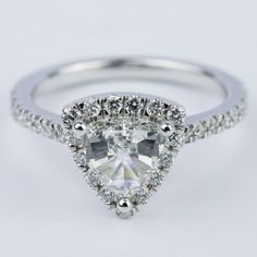 an engagement ring with a pear shaped diamond center