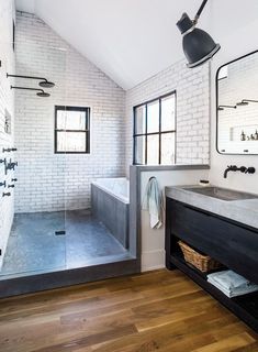 a bathroom with a sink, mirror and bathtub