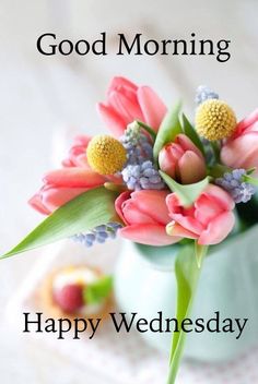 a vase filled with pink flowers on top of a table