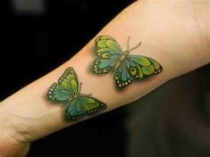 three green butterflies on the left forearm and right arm, with black dots around them